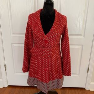 Red belted coat with gray poka dots.